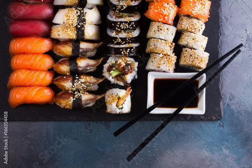 Canvas Print Japanese sushi big set with two wooden black chopsticks, top view