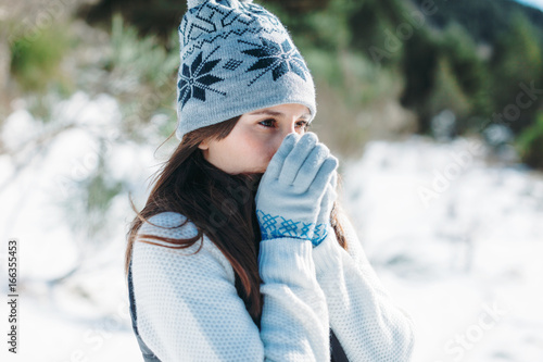 Closeup of a young woman on a cold snowy day. photo