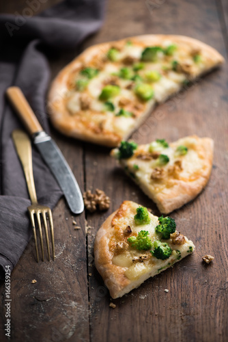 Italian pizza with taleggio cheese, broccoli and walnut