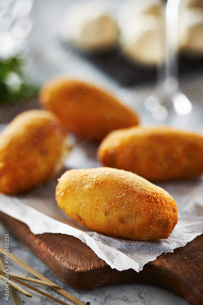 Croquettes on wooden board Croquettes on wooden board