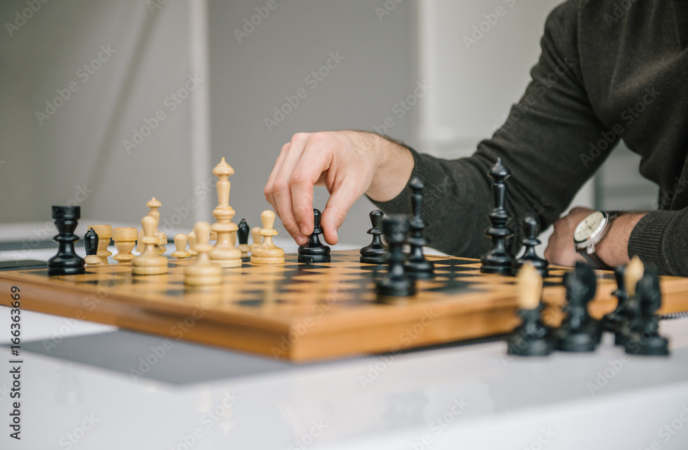 Male Hand Moving Chessman on the Chessboard Male Hand Moving Chessman on the Chessboard