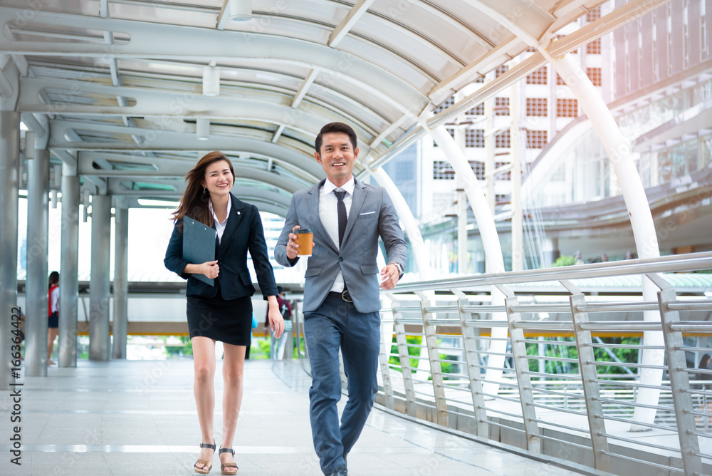 Businessman and businesswoman walking with happiness mood face, Happiness conscept, Business concept Businessman and businesswoman walking with happiness mood face, Happiness conscept, Business concept