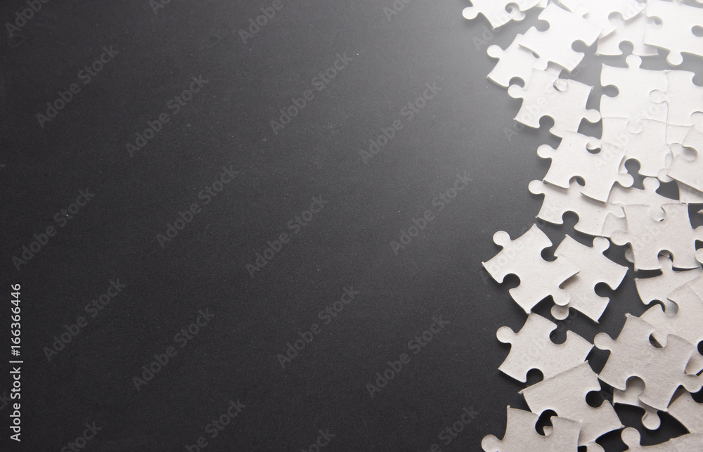 Puzzle pieces on a black slate with Text Space - obrazy, fototapety, plakaty 