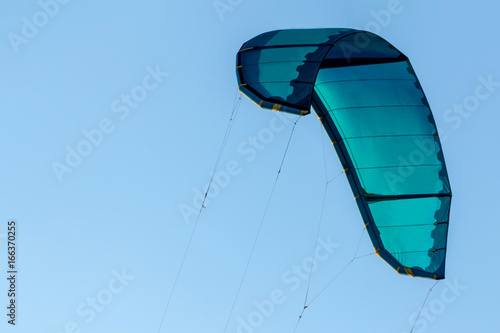 Photography Sport turquoise kite for surfing in the air.