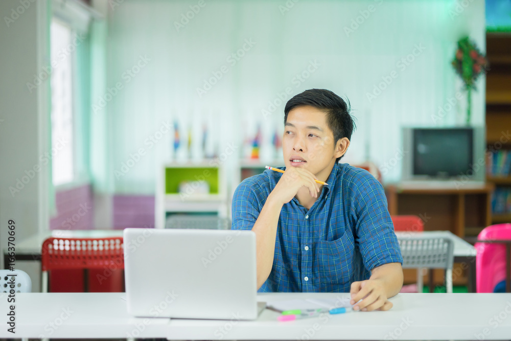 Asian male university college student Thinking looking up to the empty blank copy space,Thoughtful teenage schoolboy think about something while sitting at desk in classroom,education concept Asian male university college student Thinking looking up to the empty blank copy space,Thoughtful teenage schoolboy think about something while sitting at desk in classroom,education concept
