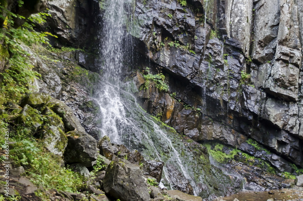 Under part of fresh Boyana waterfalls in deep forest and rock, Vitosha, Bulgaria  