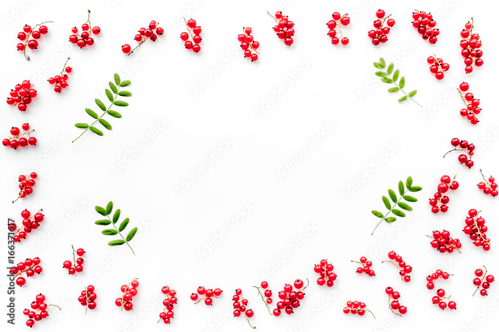 Berry frame. Red currant and leaves on white background top view copyspace Berry frame. Red currant and leaves on white background top view copyspace