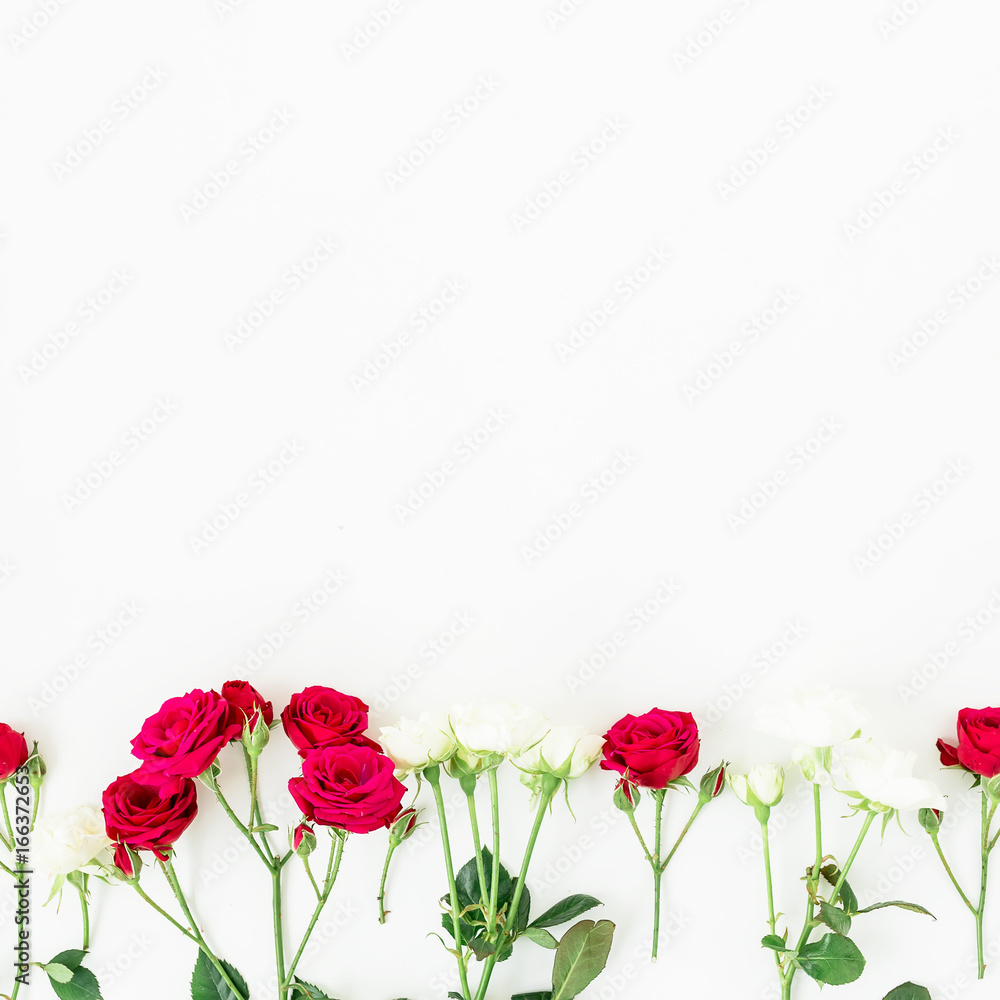 Obraz premium Floral composition with red roses and leaves isolated on white background. Flat lay, top view. Floral background