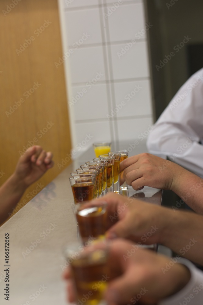 Men with alcohol shots on the bar Men with alcohol shots on the bar
