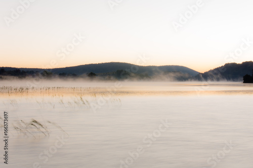 Mist at sunrise on Lake Ilay, in the French Jura
