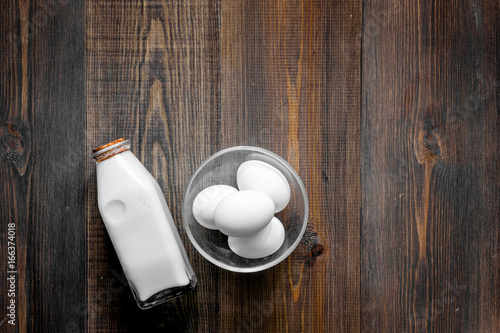 Non GMO, prservatives-free organic food. Milk, eggs on dark wooden background top view copyspace
