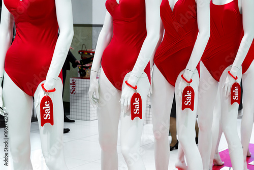 series of mannequins in red swimsuits. Sale photo