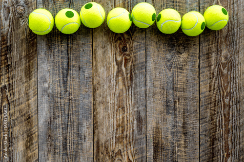 Sport gear. Tennis balls wooden background top view copyspace © 9dreamstudio