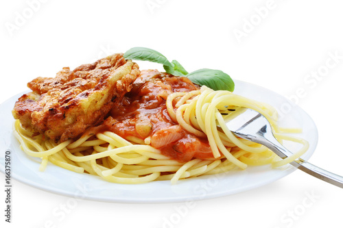 Schnitzel with spaghetti, tomato sauce and basil on white plate isolated - Piccata milanese photo