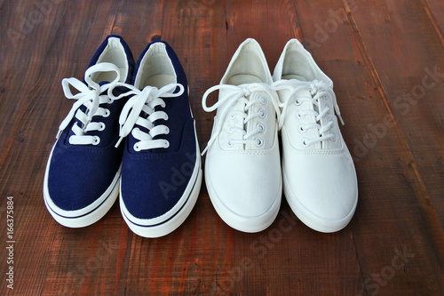 Blue and white denim sneakers two pairs new unbranded on wooden background