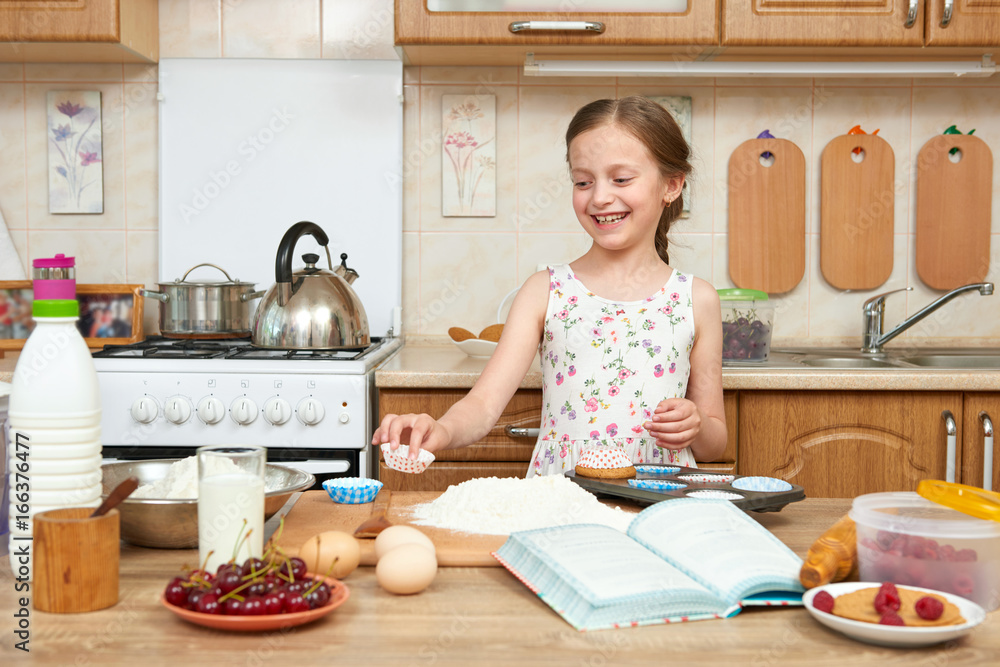 Girl baking cookies. Home kitchen interior. Healthy food concept Girl baking cookies. Home kitchen interior. Healthy food concept