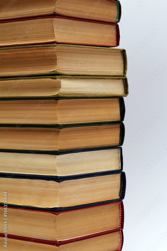 stack of different old books on a white background stack of different old books on a white background