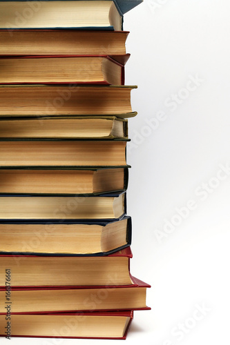 stack of different old books on a white background