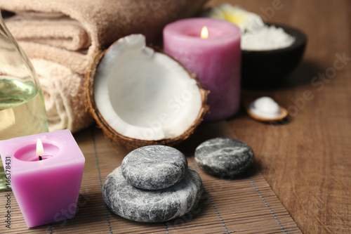 Beautiful spa composition with coconut and candles on table