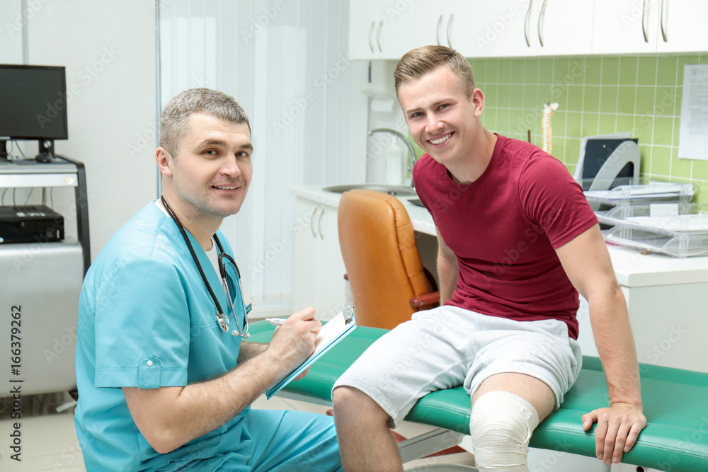 Fototapeta premium Orthopedist examining patient in clinic