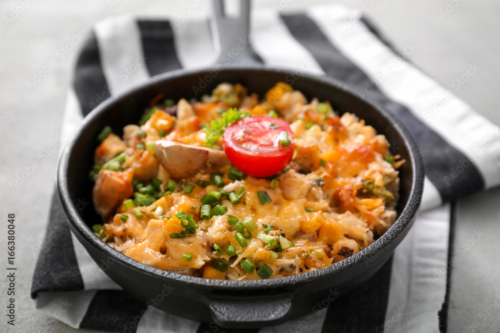 Frying pan with delicious turkey casserole on table, closeup Frying pan with delicious turkey casserole on table, closeup