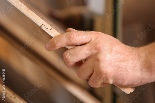 Carpenter choosing laminate samples in hardware store