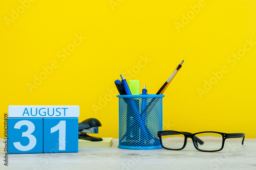 August 31st. Image of august 31, calendar on yellow background with office supplies. Summer time end. Back to school concept photo