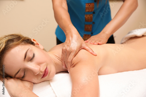 Young woman having massage ...