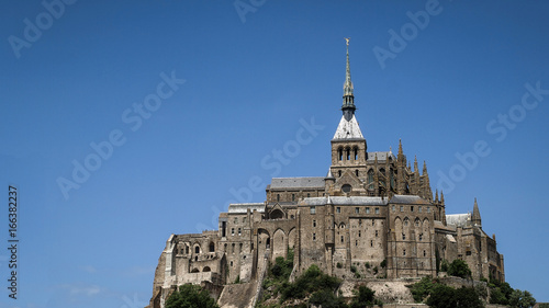 Panoramic view of Mont-Saint-Michel monastery with blue sky in the background.France, Europe.