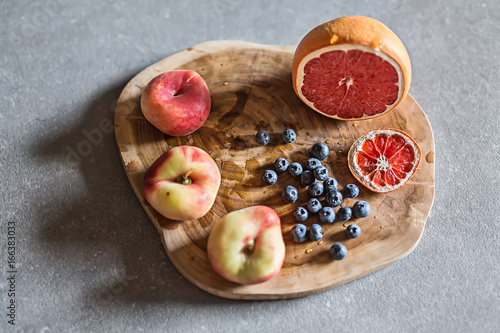 Fresh and juicy fruit on wooden board