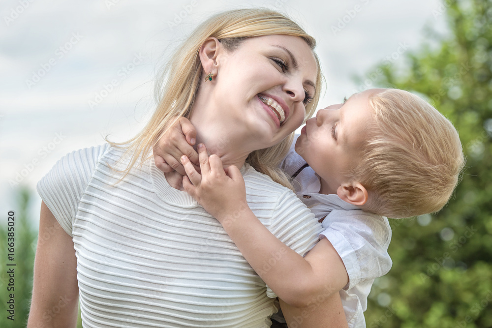Life moment of happy family!Little boy tenderly embraces his mother. Life moment of happy family!Little boy tenderly embraces his mother.