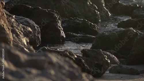 Slow Motion Waves Crashing Among Rocks on Beach