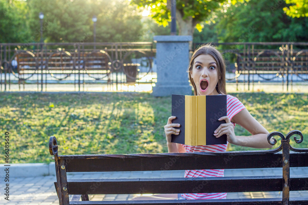 Shocked Walk In Surprised and shocked girl with a book in the park. Human emotion ...