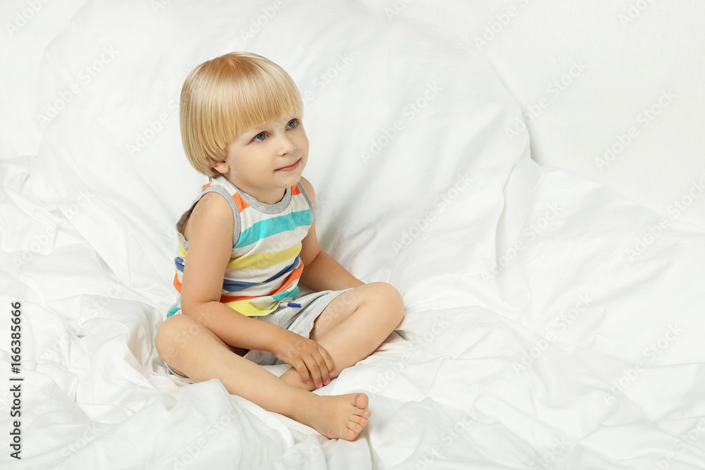 Little boy sitting in white bed Little boy sitting in white bed