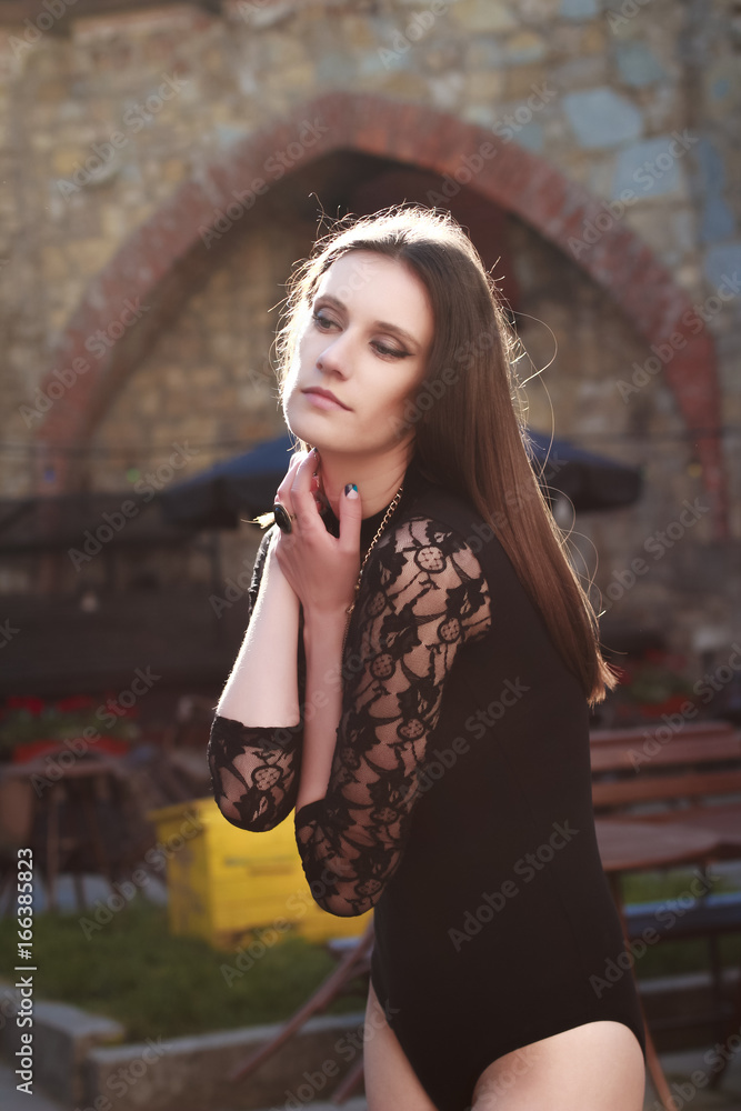 Obraz premium Tender brunette model in lace underwear posing at the street