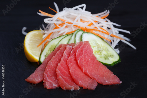 Tuna sashimi served on black slate. Sushi restaurant concept