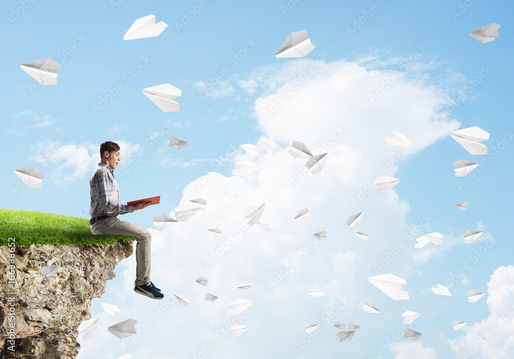 Handsome student guy with book in hands preparing for exam Handsome student guy with book in hands preparing for exam