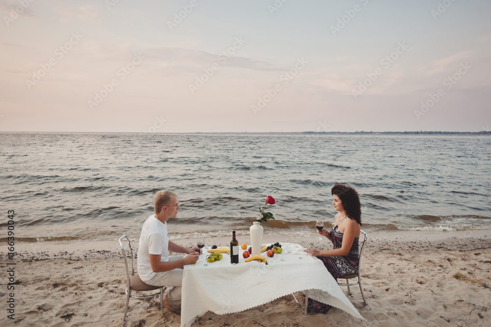 Couple in love gathered to have dinner by the water