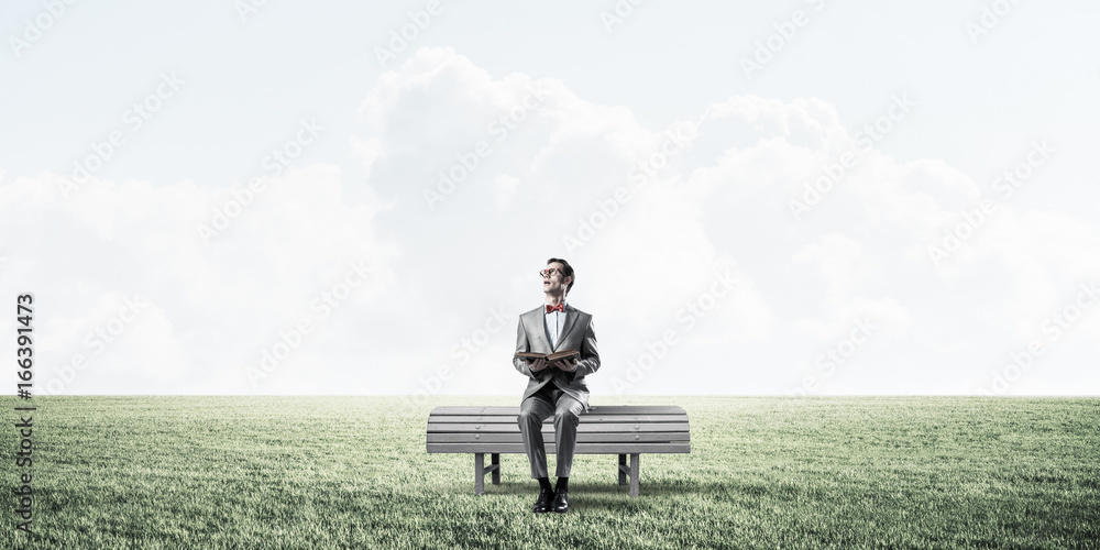 Young businessman or student studying the science in summer park Young businessman or student studying the science in summer park