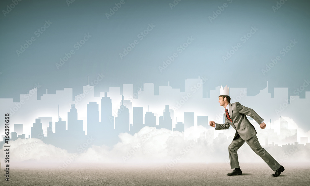 King businessman in elegant suit running and blue cityscape silh King businessman in elegant suit running and blue cityscape silh