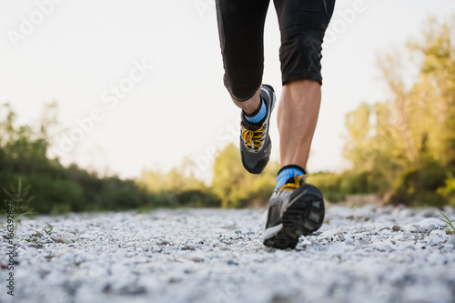 Strong man doing workout outdoor photo