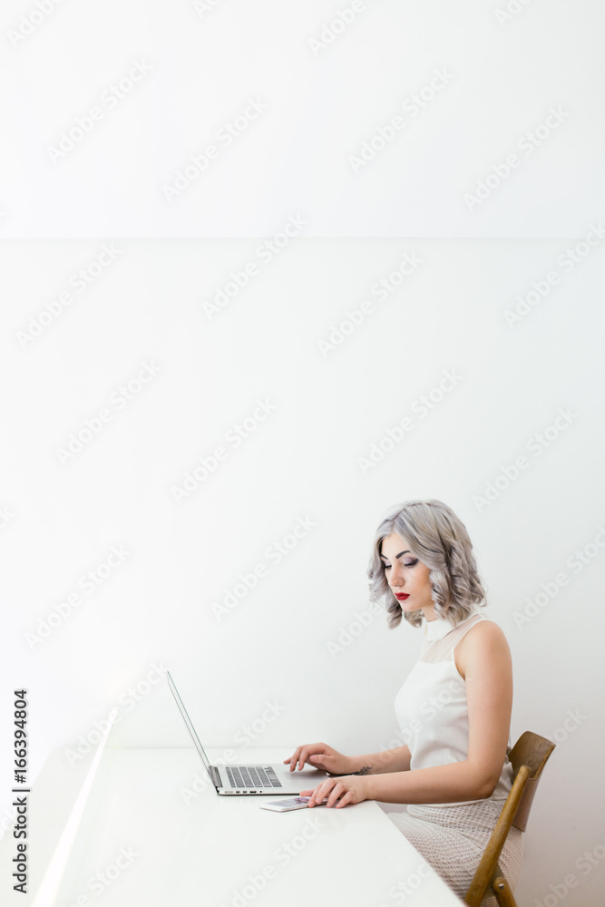 Stylish woman working in the white office