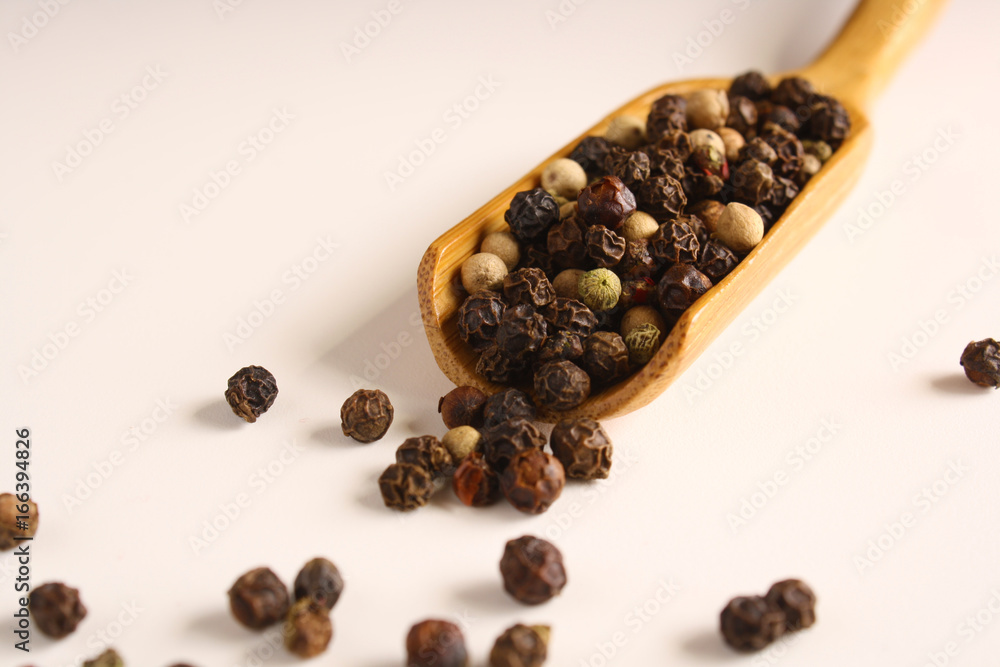 Pepper peas white black red in a wooden spoon Pepper peas white black red in a wooden spoon