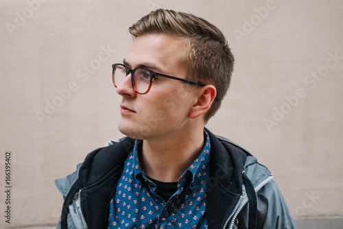 side profile portrait of young man in city photo