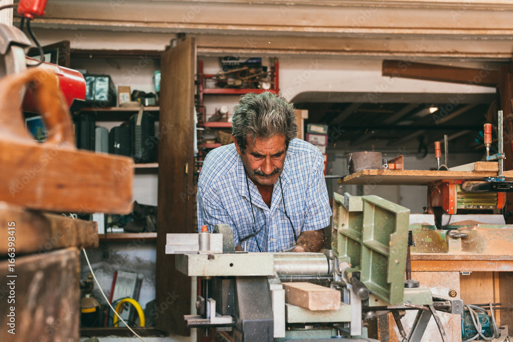 Senior Carpenter Working in His Workshop Senior Carpenter Working in His Workshop