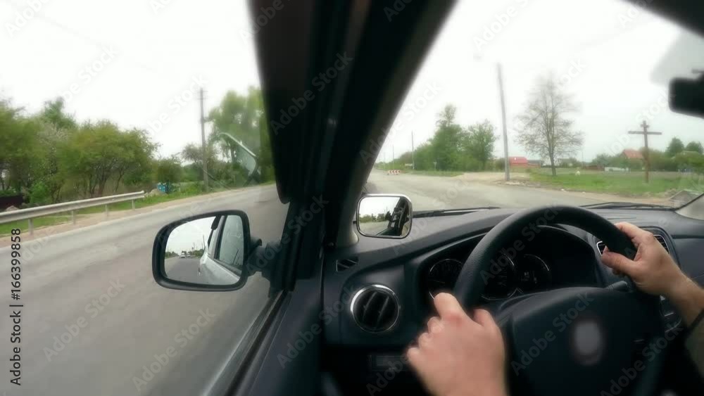 Travel, trip by car. Driver behind the wheel in car and rearview mirror. Traffic timelapse along the highway. High speed, road and roadside, oncoming cars. Vehicle hyperlapse Travel, trip by car. Driver behind the wheel in car and rearview mirror. Traffic timelapse along the highway. High speed, road and roadside, oncoming cars. Vehicle hyperlapse