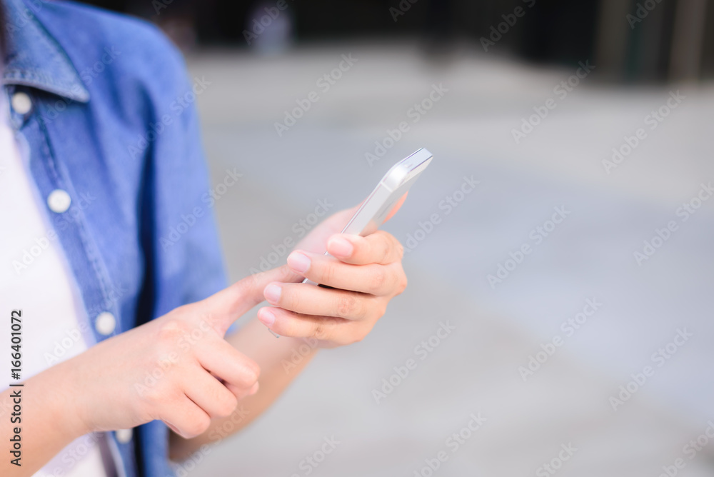young asian woman use smartphone at city