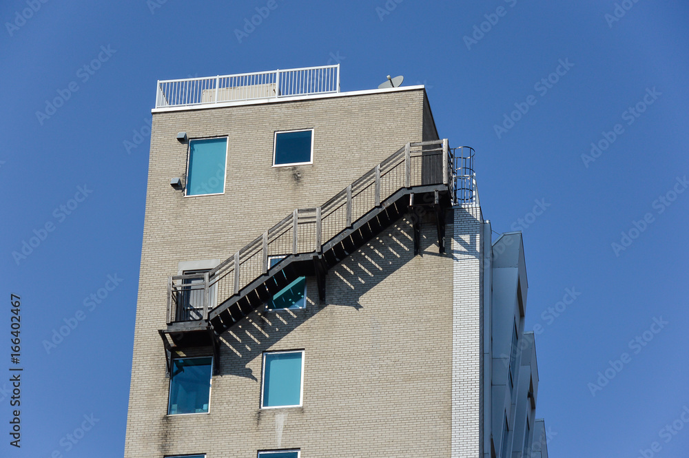 Fire escape ladder on modern building in Montreal downtown, QC, Canada Fire escape ladder on modern building in Montreal downtown, QC, Canada
