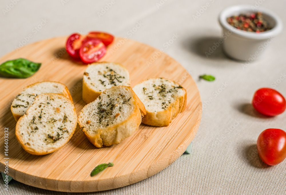 Bread toasts with spices and herbs against white background Bread toasts with spices and herbs against white background