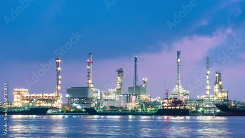 Oil refinery plant and shipping loading dock at twilight.